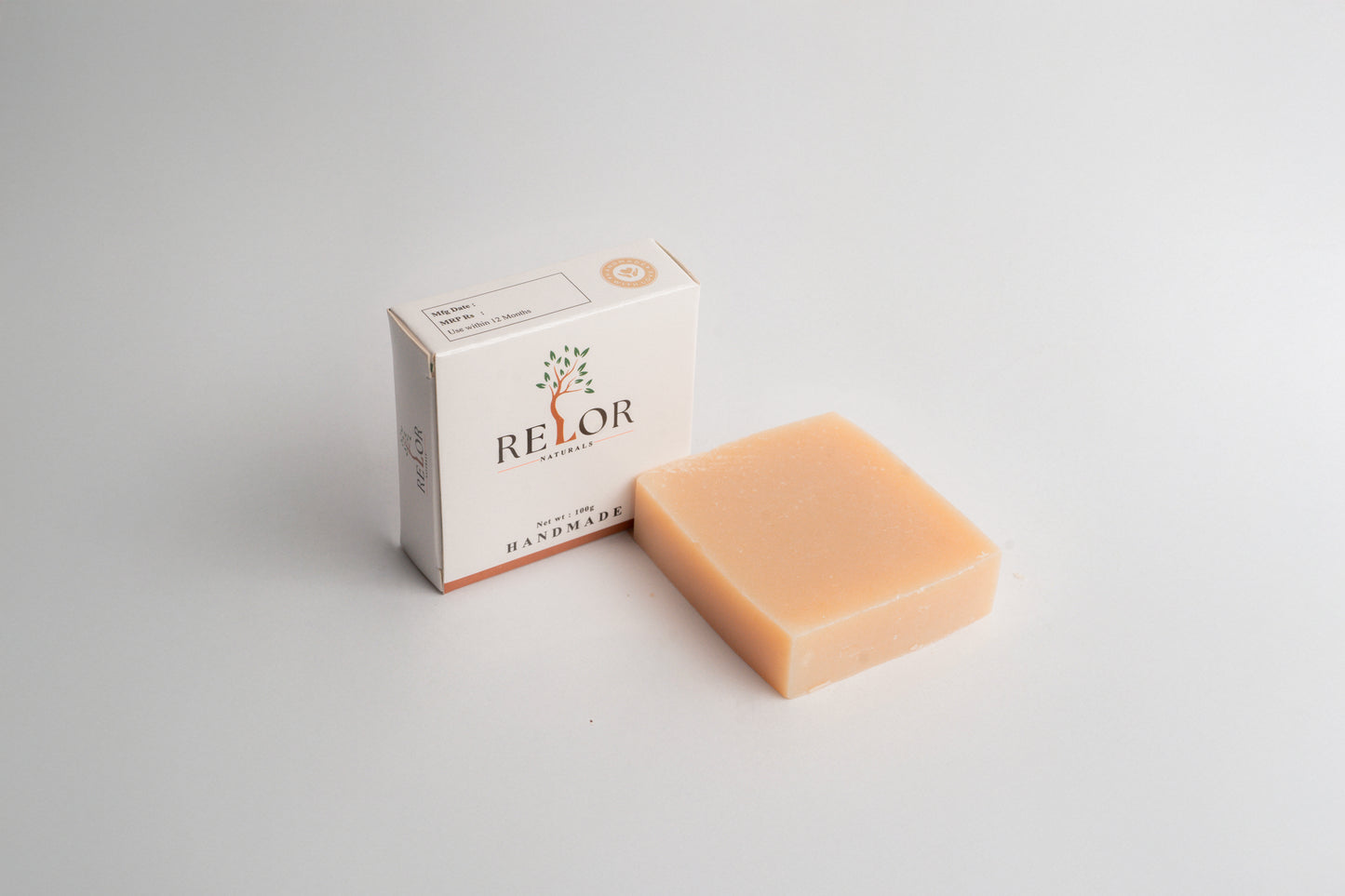 Handmade natural soap bar with RELOR NATURALS packaging for soft and healthy skin