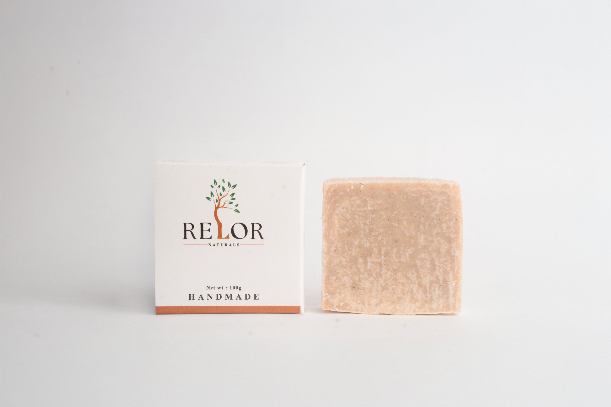 Handmade natural soap bar with RELOR NATURALS packaging for soft and healthy skin