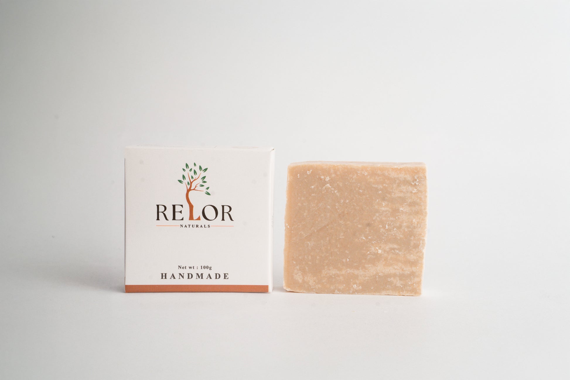 Handmade natural soap bar with RELOR NATURALS packaging for soft and healthy skin